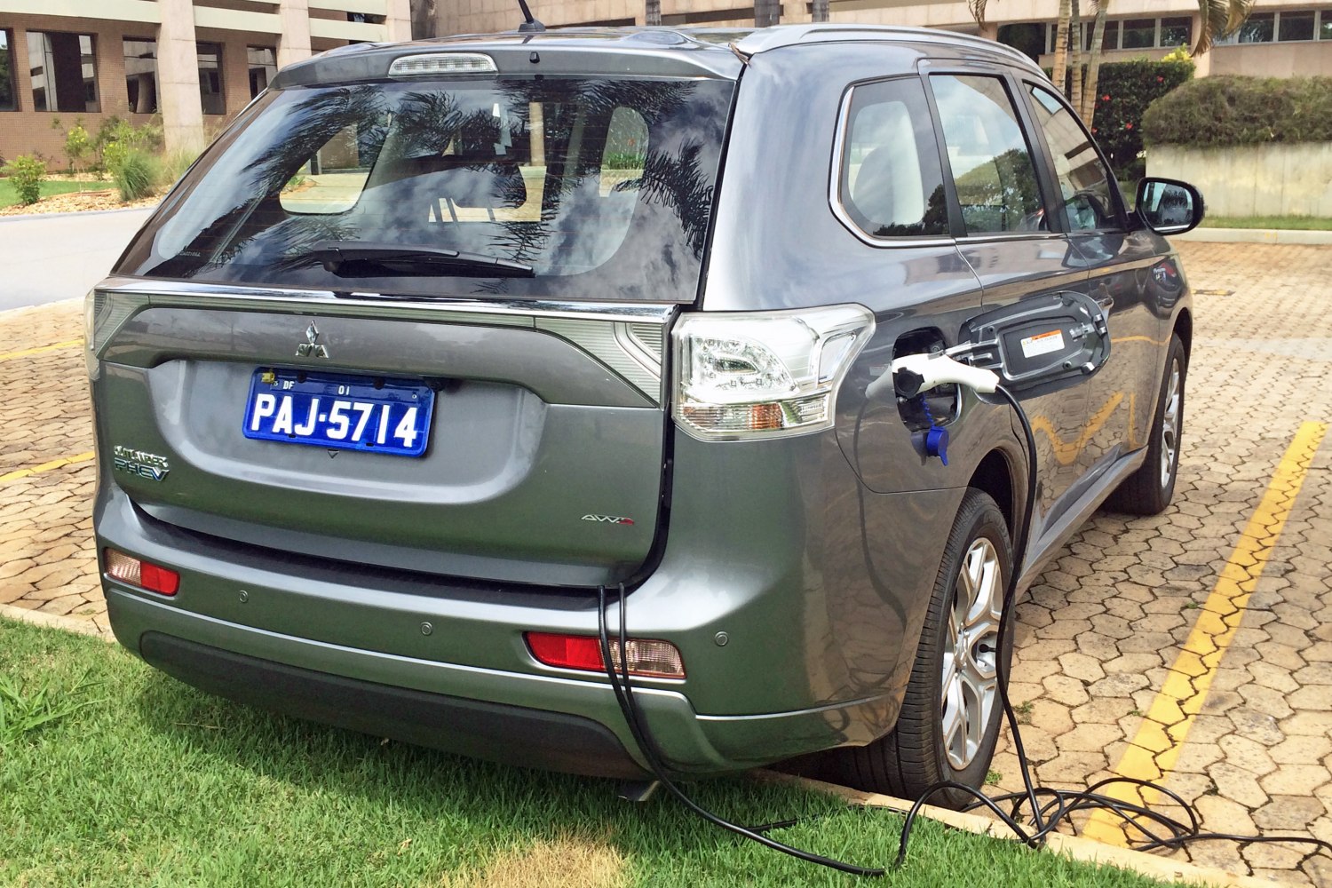 Rear view of plug-in hybrid SUV with charging cable connected