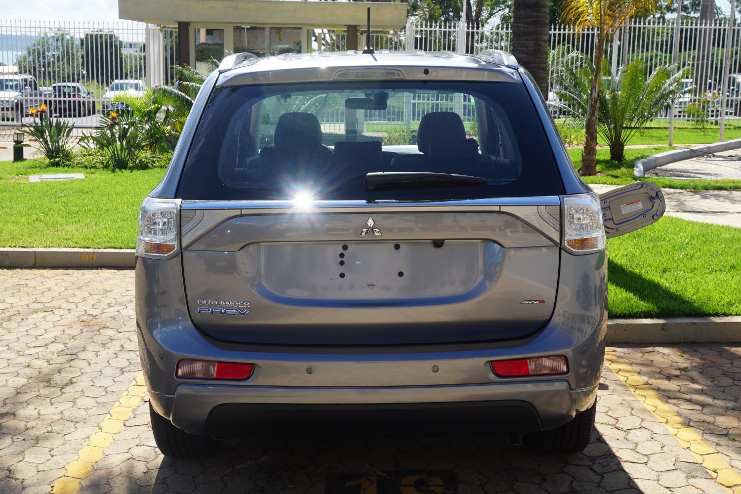 Rear view with PHEV badge, AWD emblem, and rear window wiper
