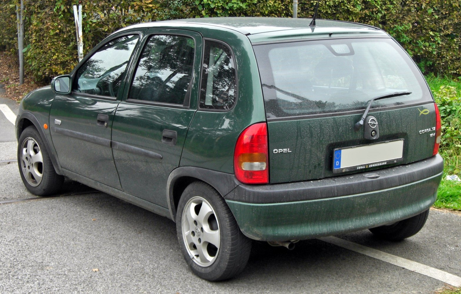 Rear side view of a compact five-door hatchback with alloy wheels and distinct taillights