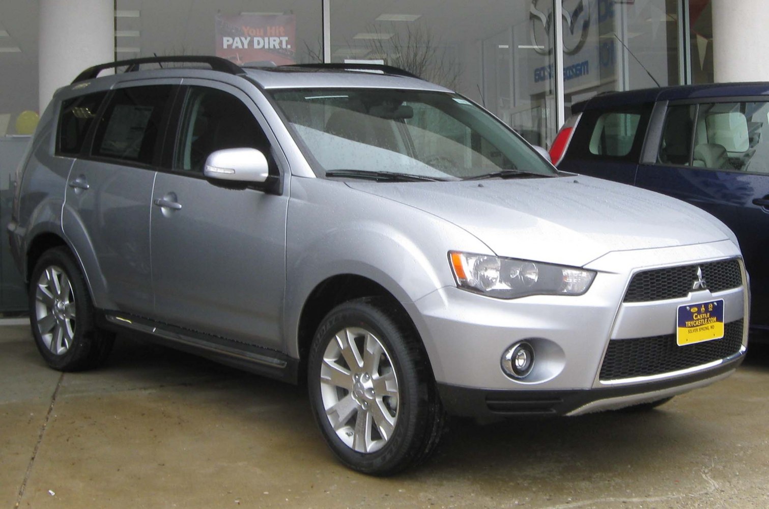 Front and side view of silver SUV with alloy wheels and distinctive grille.