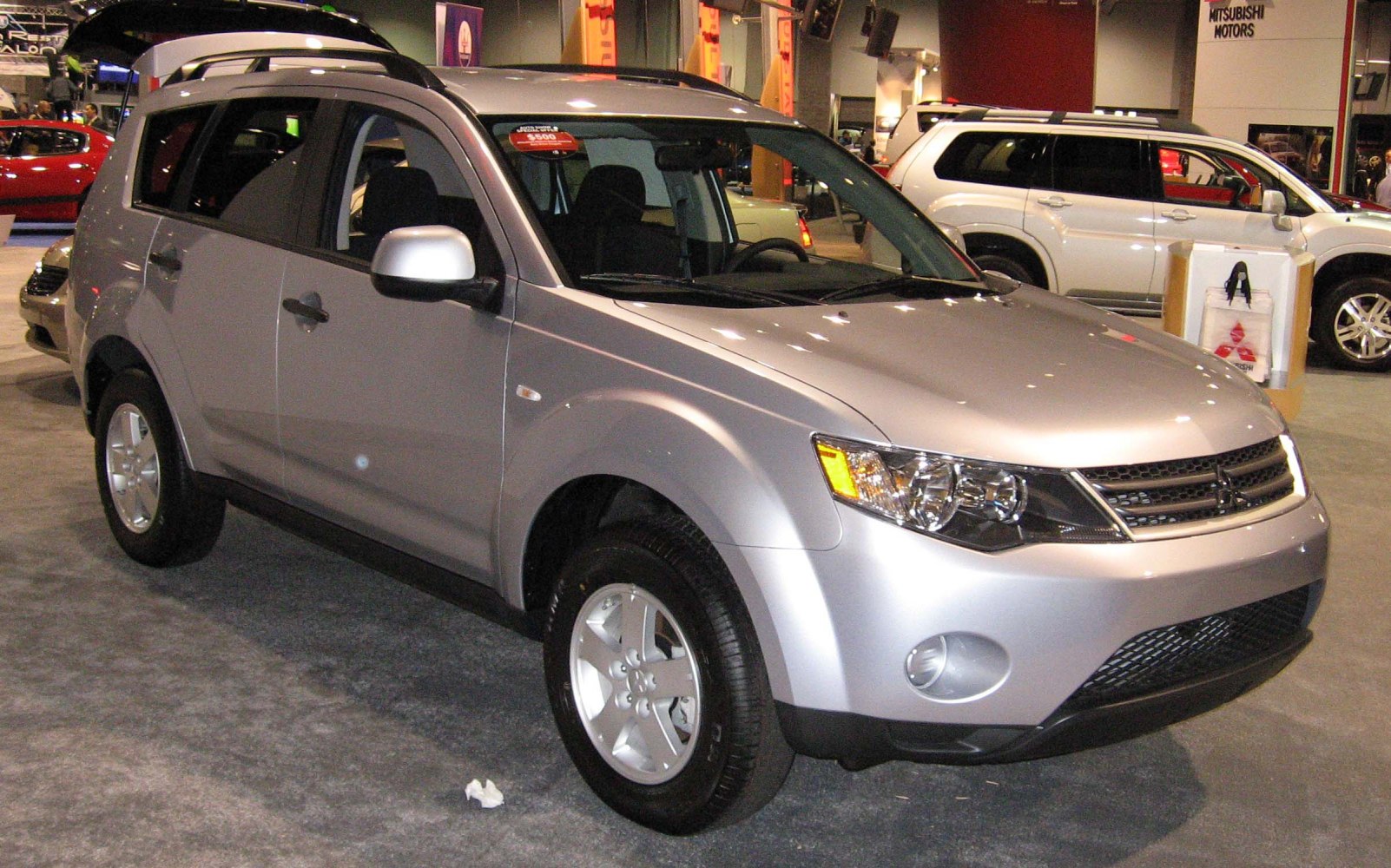 Silver SUV front side view with alloy wheels and roof rails.