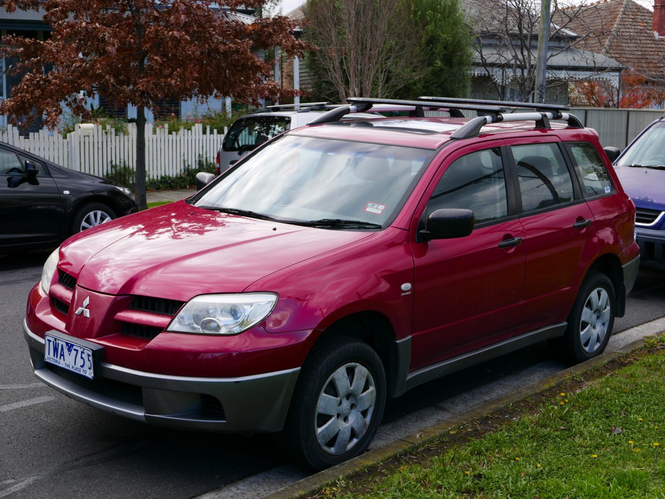 Front and side view of a compact SUV with roof rails and prominent headlights