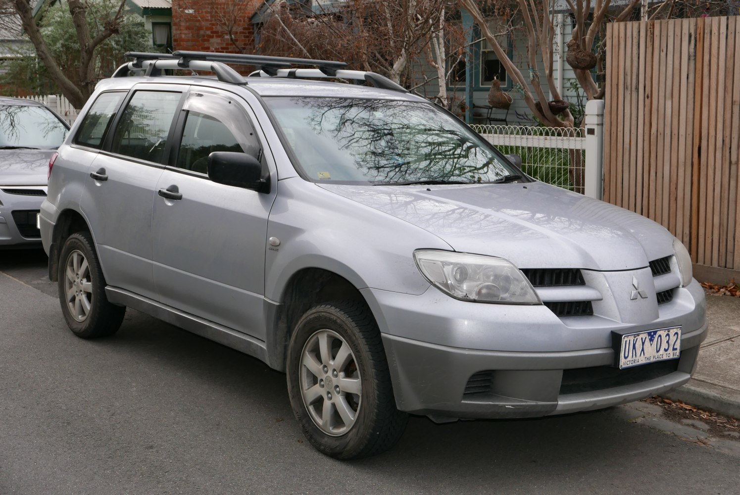 Silver SUV with roof rails and alloy wheels parked on street