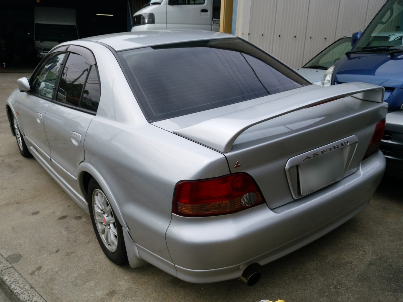 Silver sedan rear with spoiler and taillights