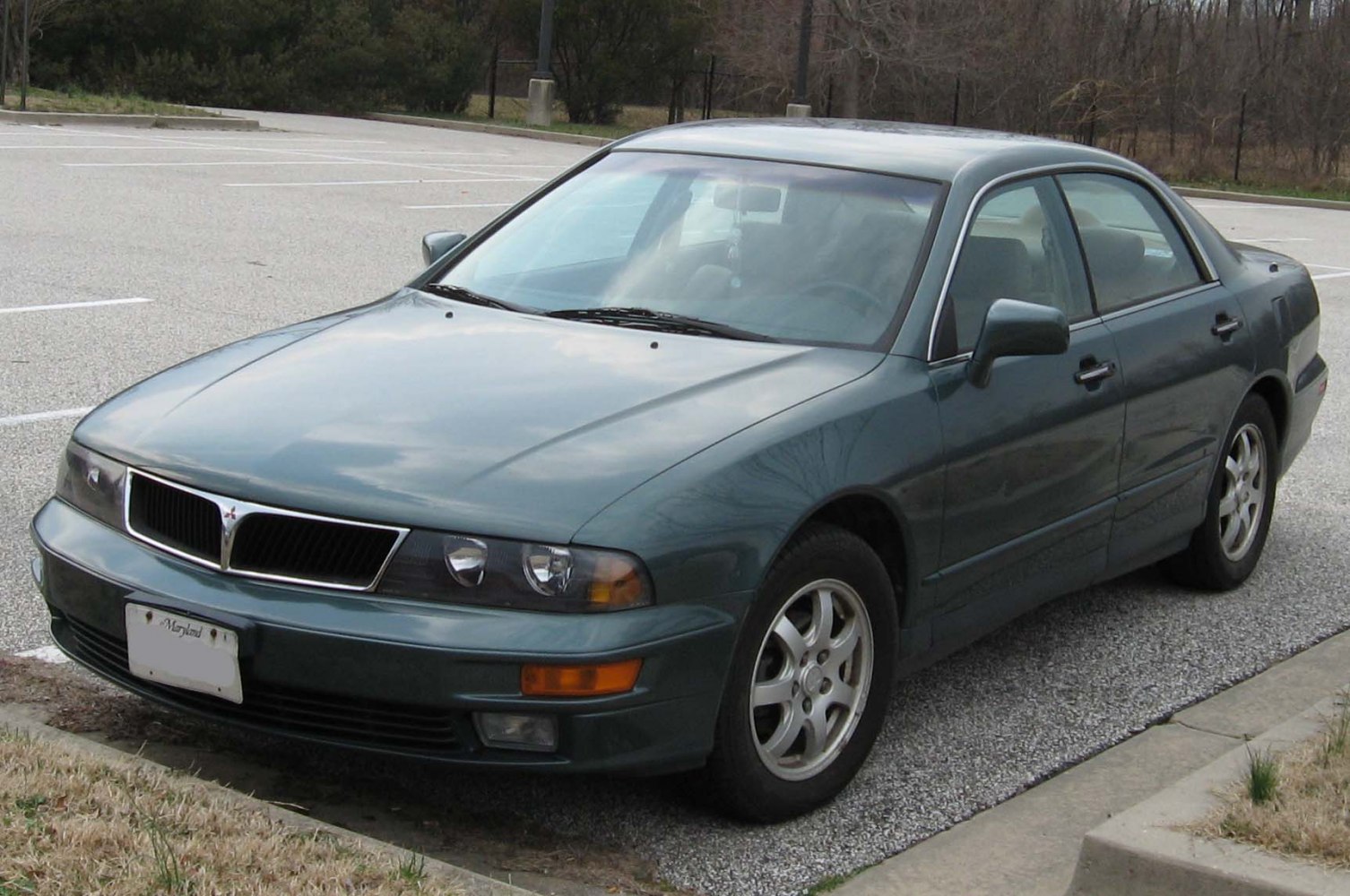 Four-door sedan with split grille and dual headlights.