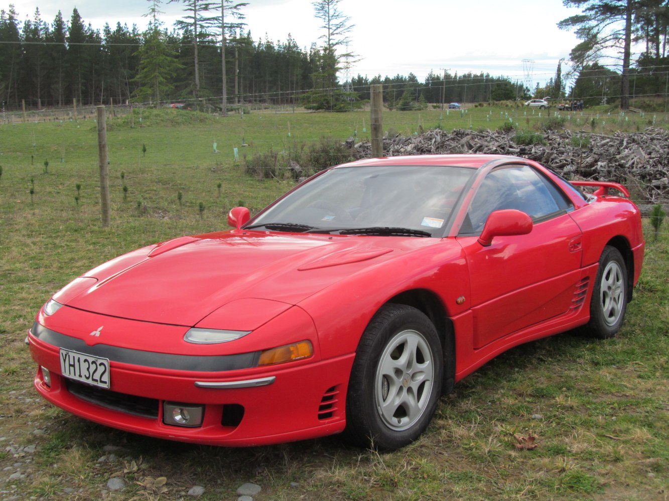 Red sports coupe with pop-up headlights and rear spoiler