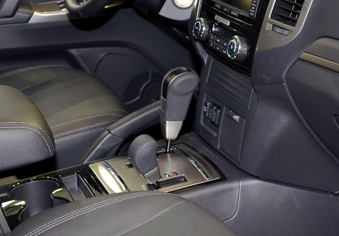 Interior view of gear shift levers and central console controls