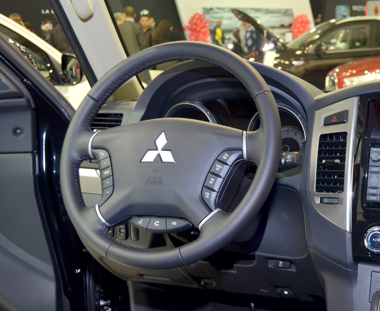 Leather steering wheel with integrated control buttons and dashboard panel