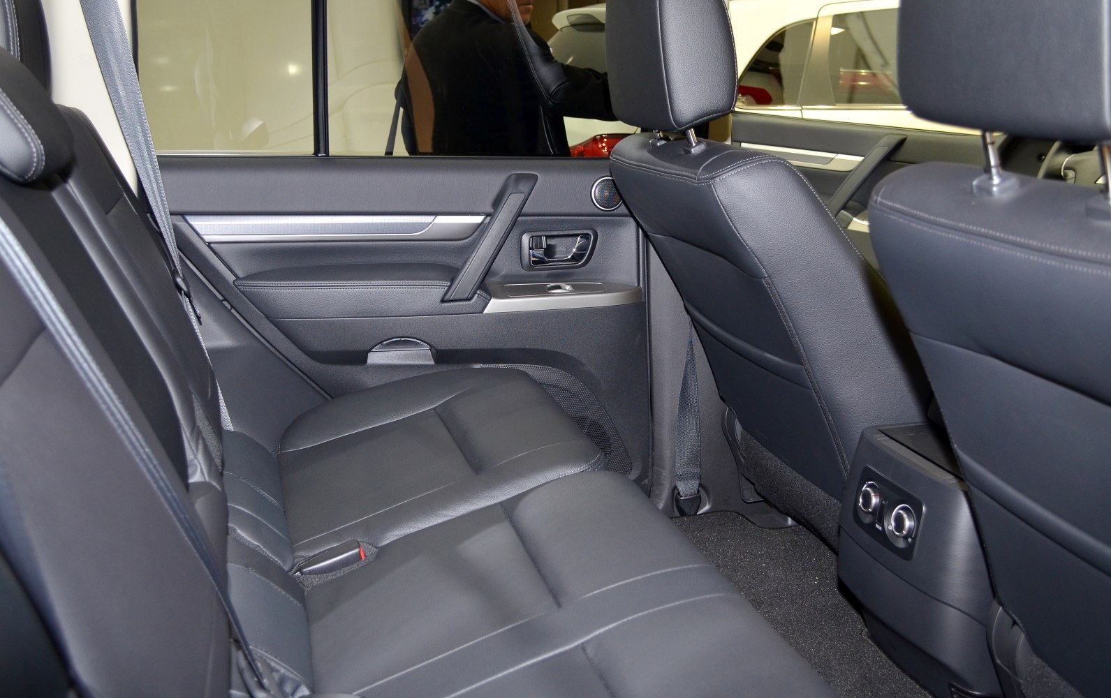 Rear seat and door panel interior with leather upholstery and controls