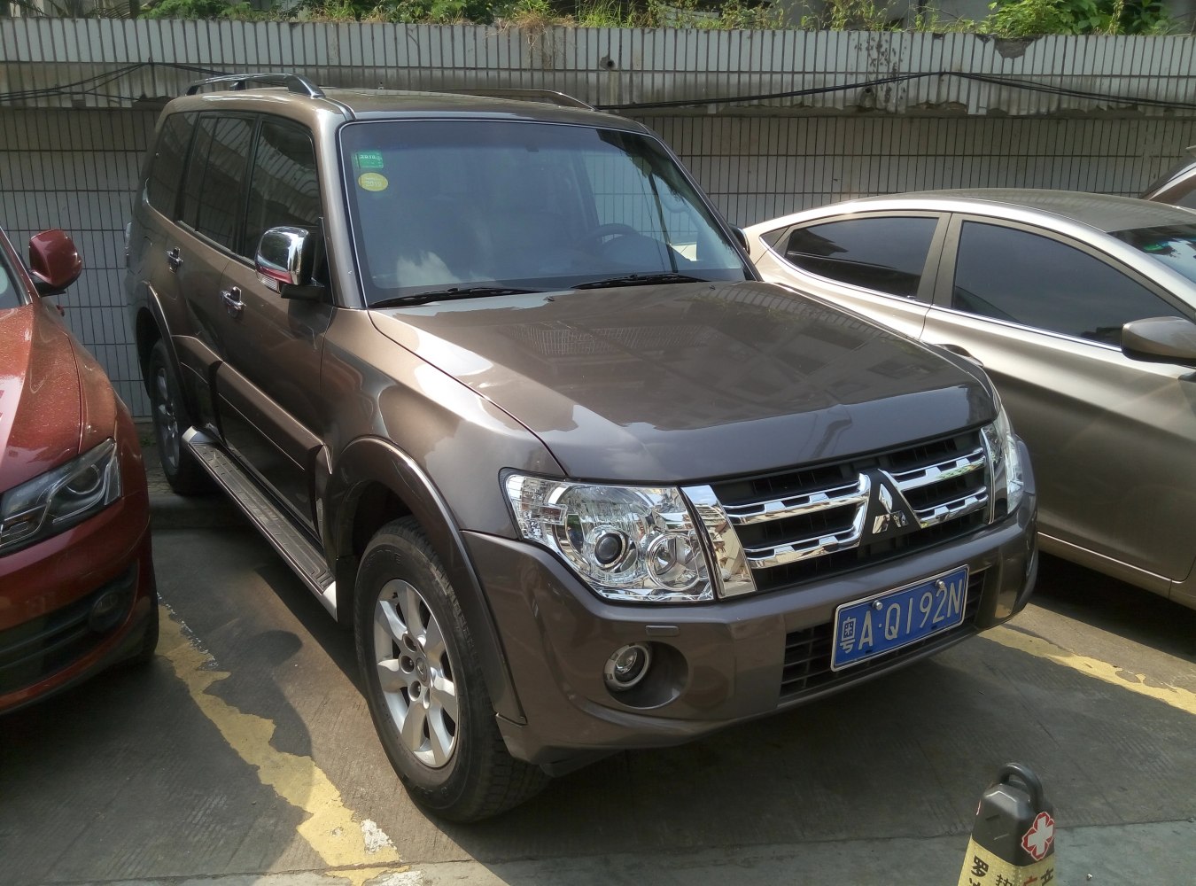 Front side view of SUV with chrome grille and fog lights