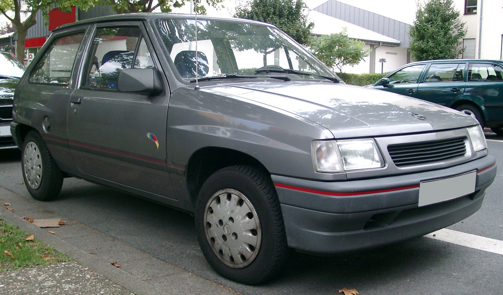 Front-side exterior view of a facelifted compact hatchback with distinct grille and headlights
