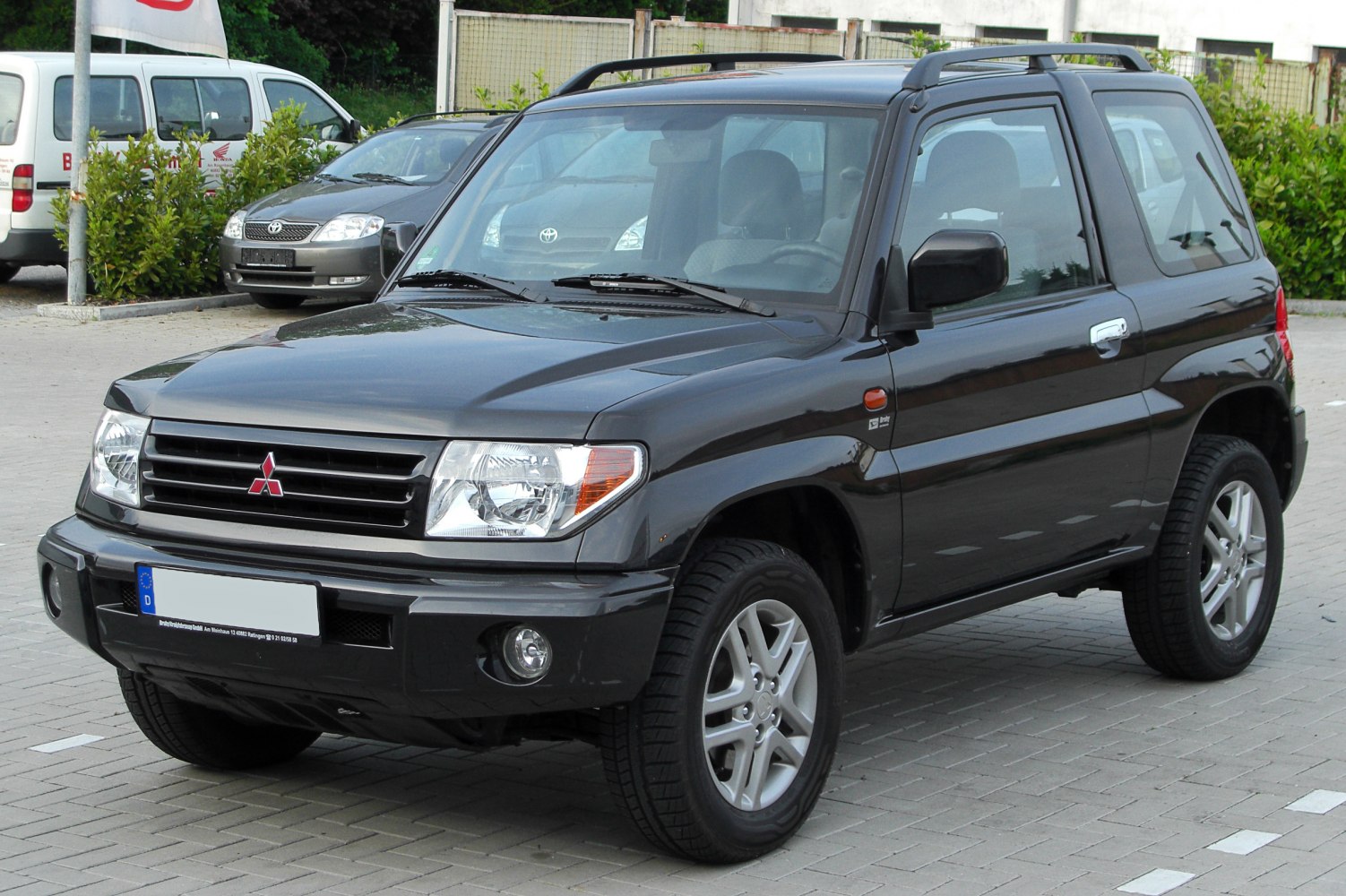 Compact SUV front view with grille, headlights, roof rails