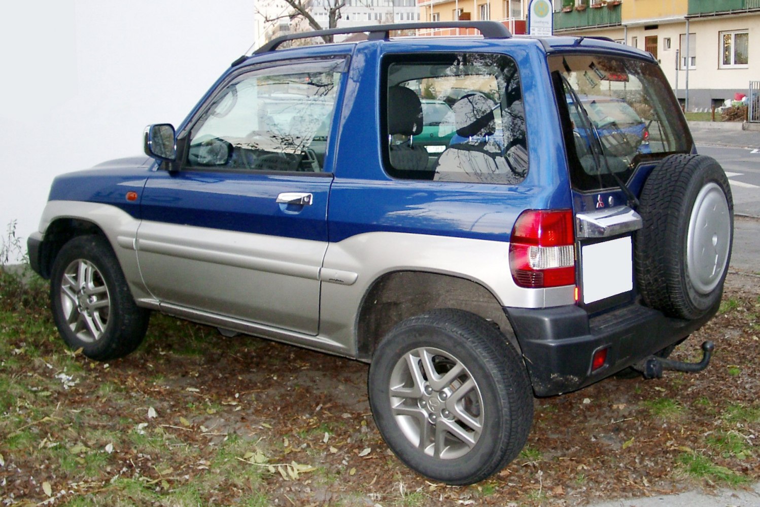 Compact two-door SUV rear side view with external spare tire