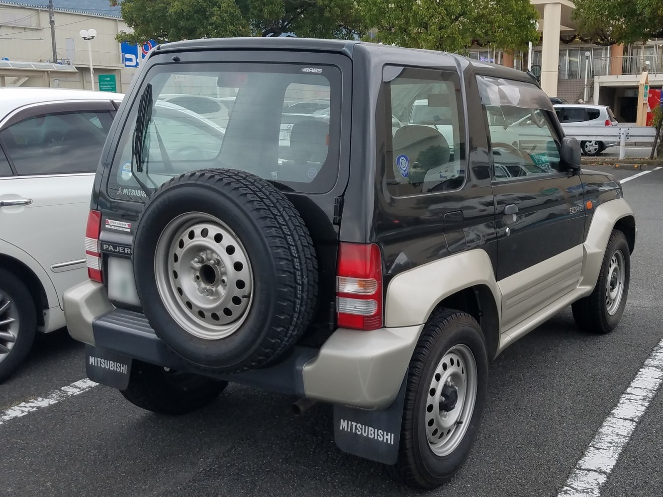Rear and side profile with spare tire on a compact SUV.