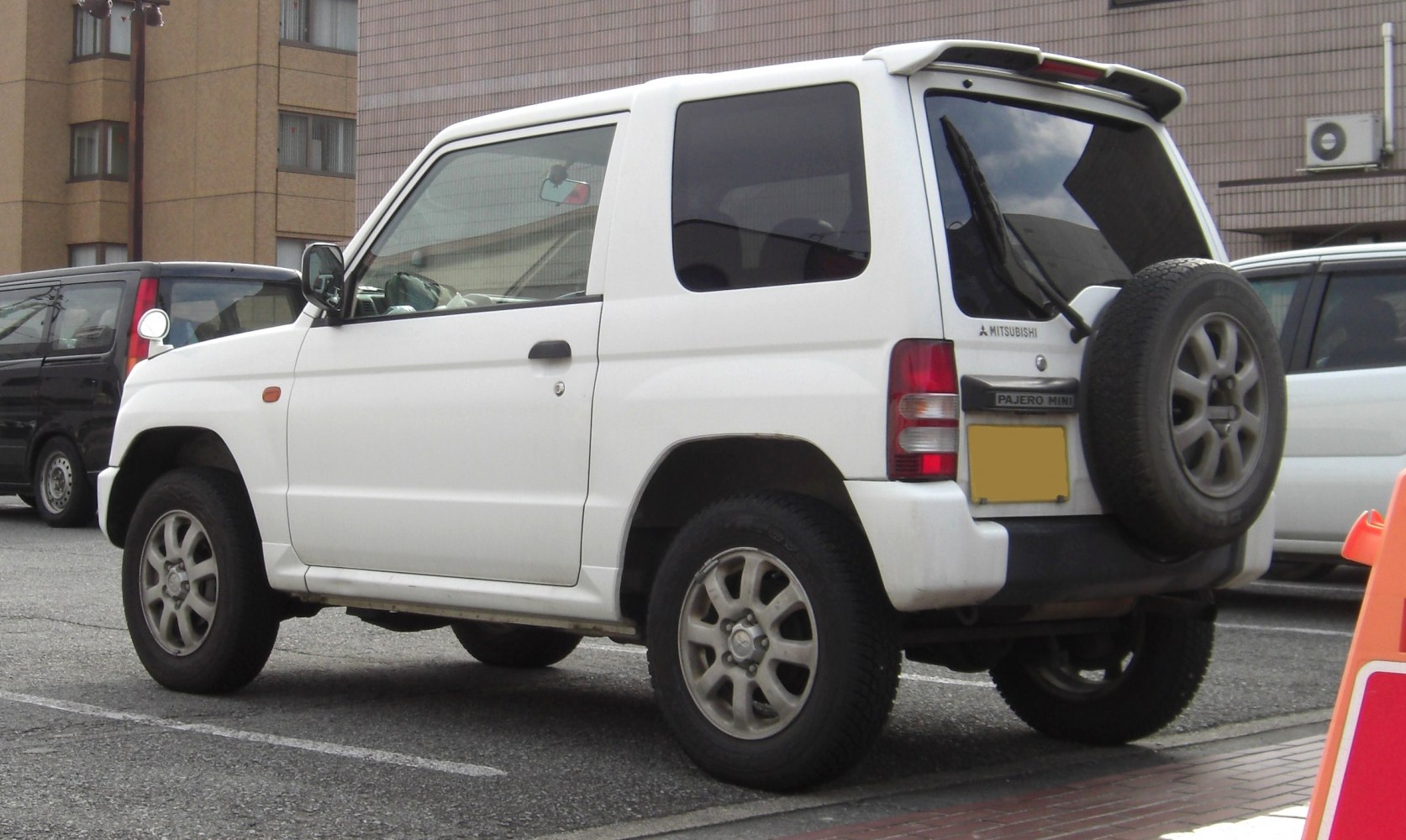 Compact SUV rear side view with spare wheel and tinted windows