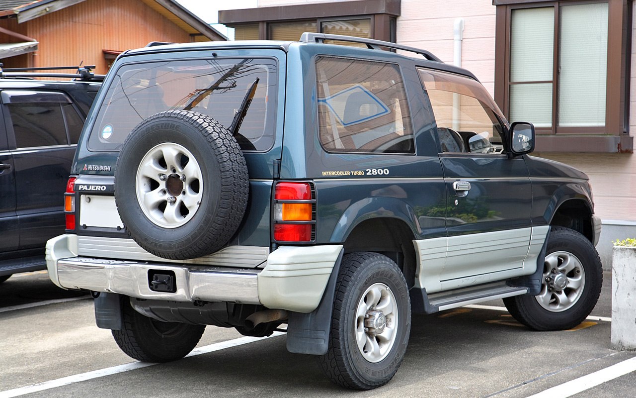 Rear-side view of SUV with rear-mounted spare tire and intercooler turbo badge