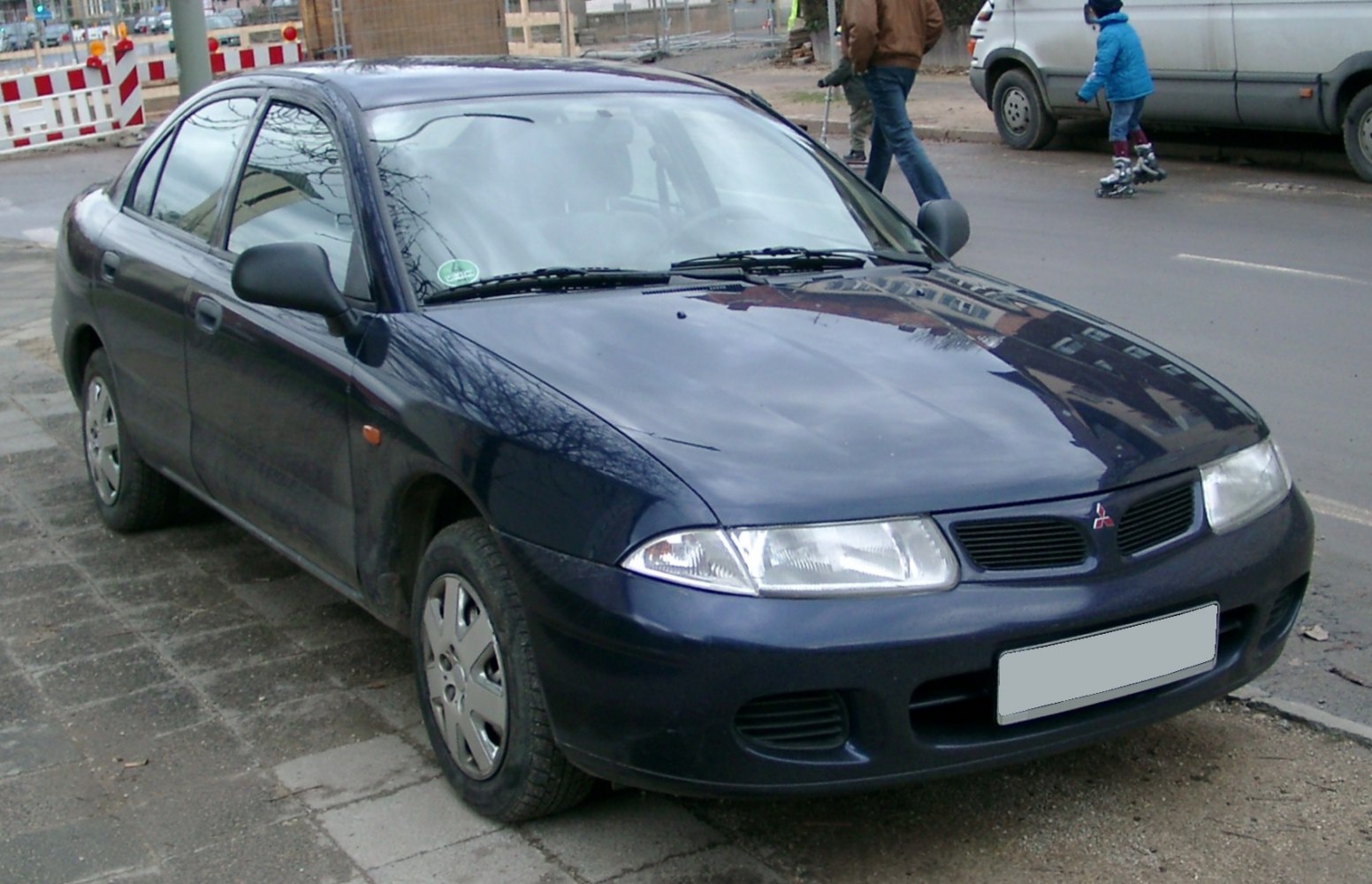 Front side view of a compact hatchback with aerodynamic design and clear headlights