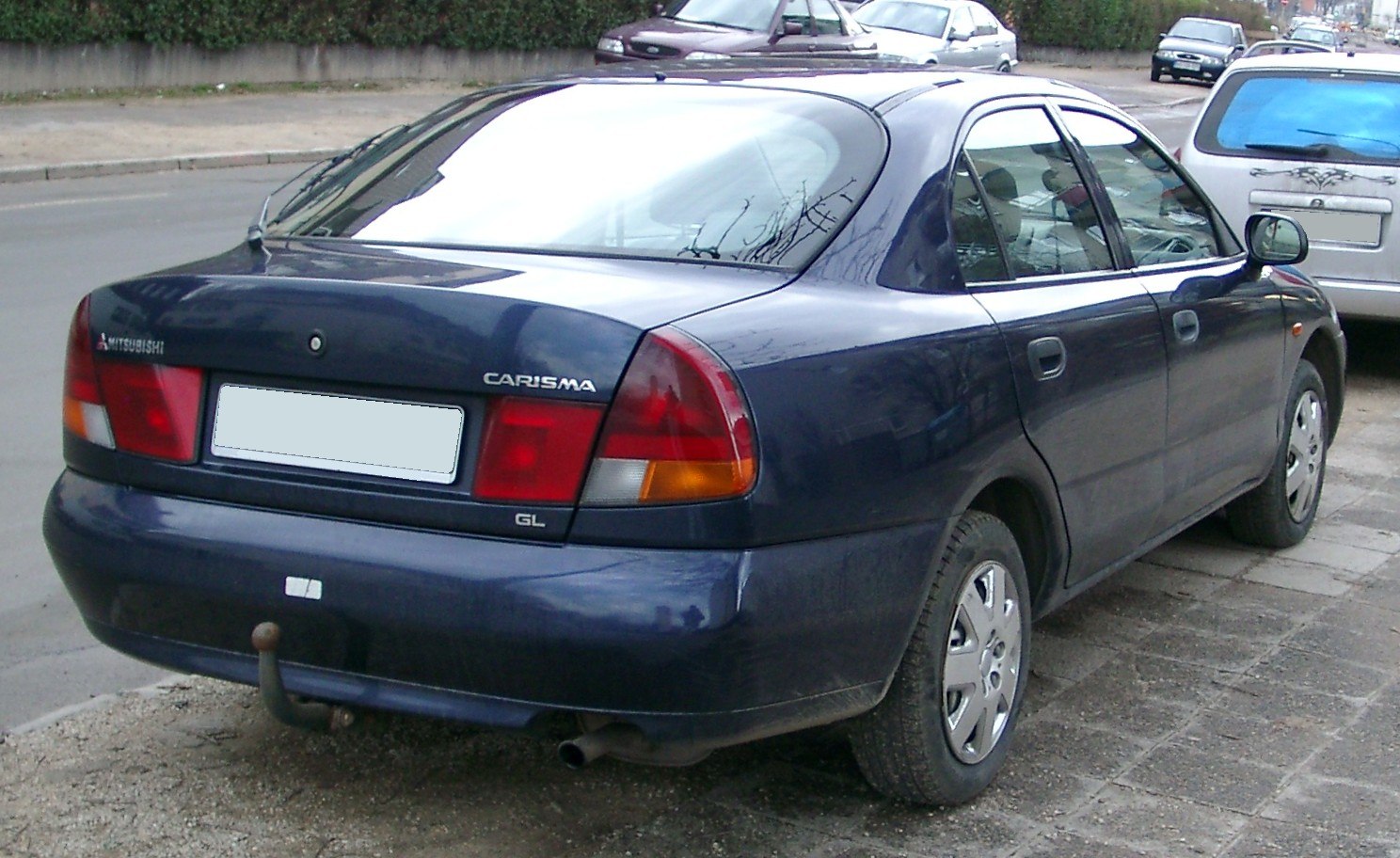 Rear view of a compact sedan with classic 90s taillight design and hatchback style