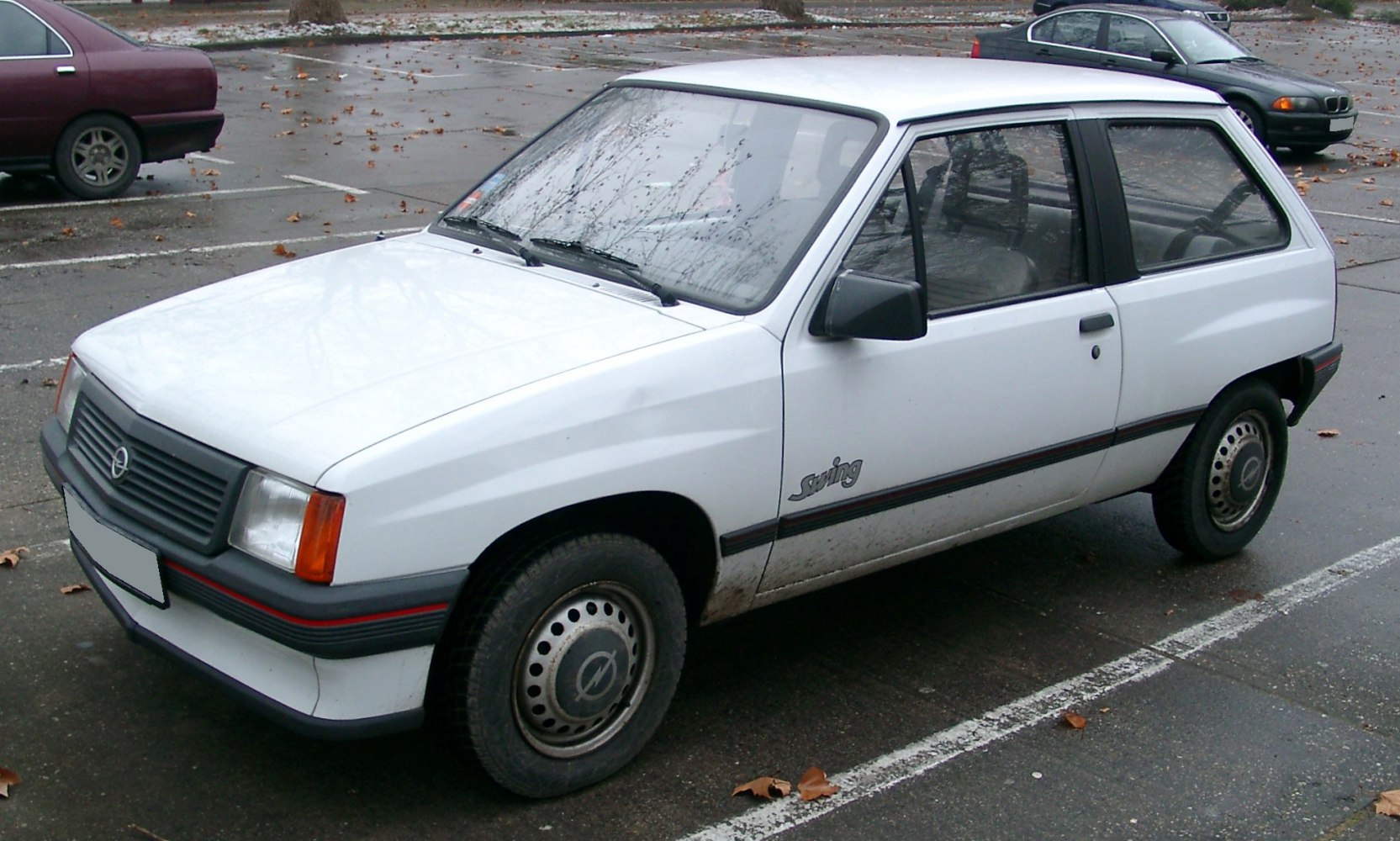 White compact three-door hatchback with classic front grille and simple design