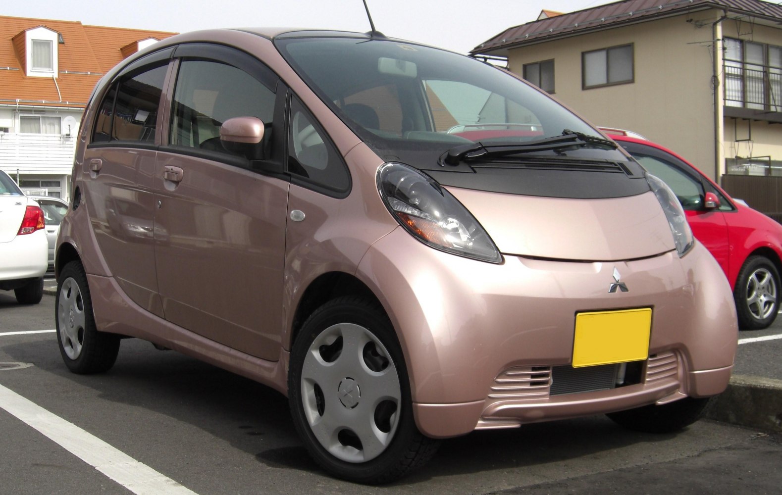 Compact car with aerodynamic headlights and sleek front angle.