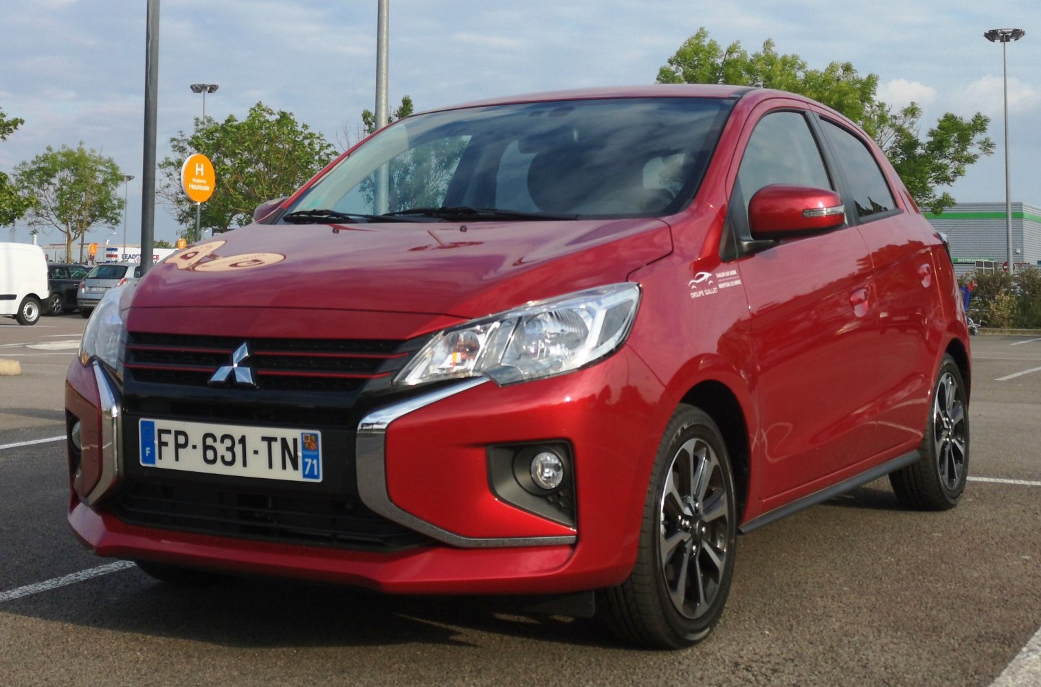 Modern red compact hatchback with updated front grille and alloy wheels