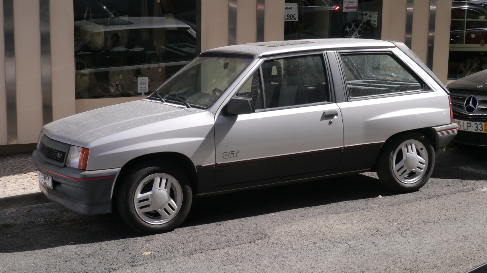 Side view of 1980s two-door hatchback with distinctive alloy wheels.