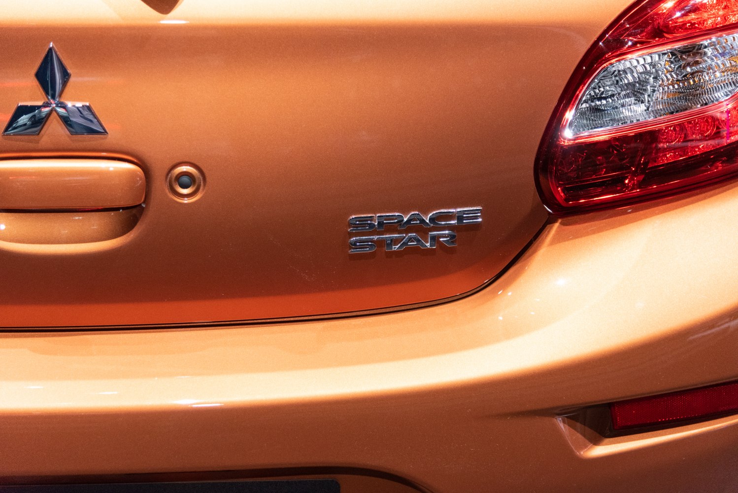 Close-up of rear badge and tail light