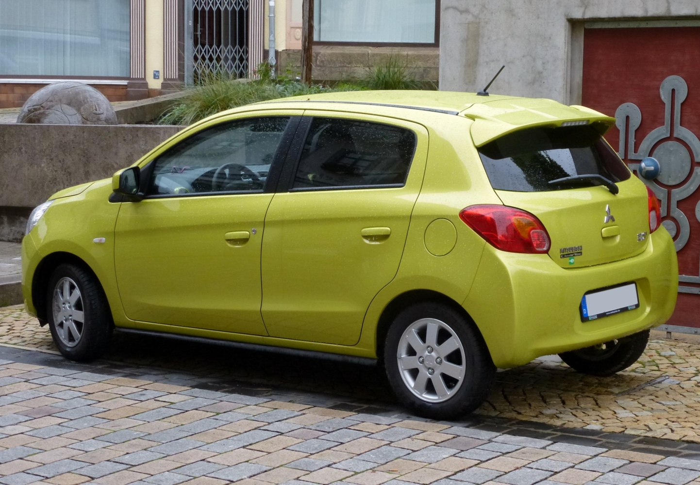 Yellow 5-door hatchback side and rear with spoiler