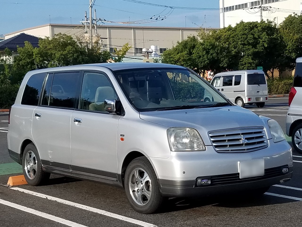 Silver Mitsubishi MPV with boxy shape and front grille