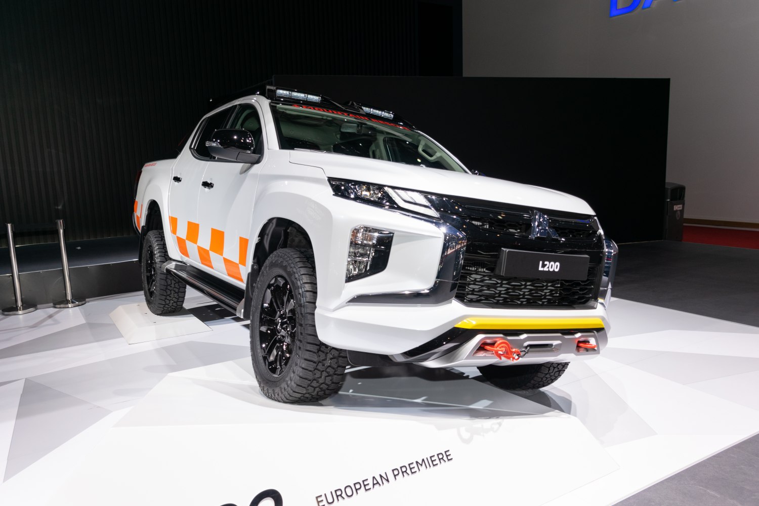 Rugged front view with LED light bar, winch, and black wheels