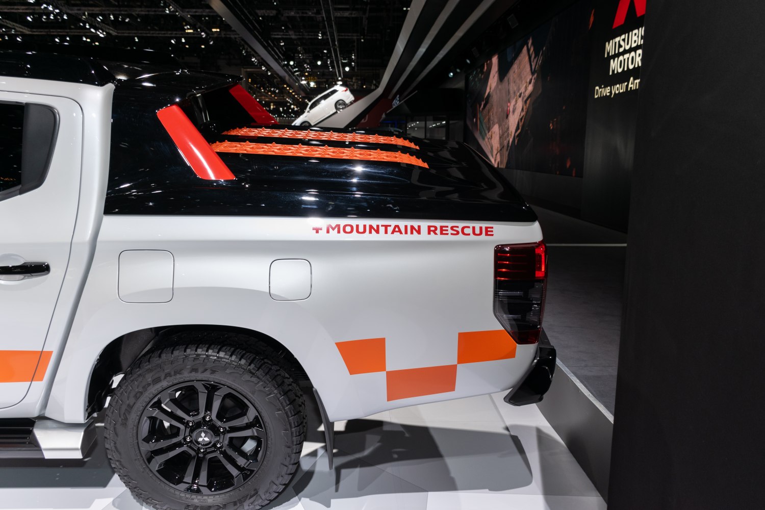 Mountain rescue pickup rear with orange decals and black wheels