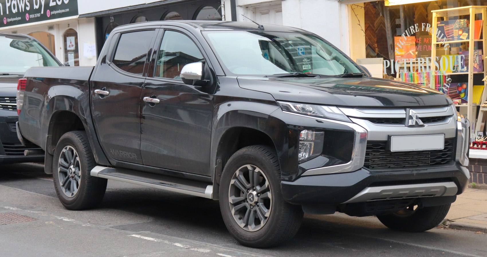 Front and side profile of a double cab pickup with modern headlights.