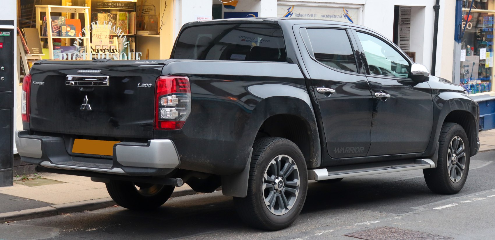 Rear and side view of pickup truck with double cab and alloy wheels.