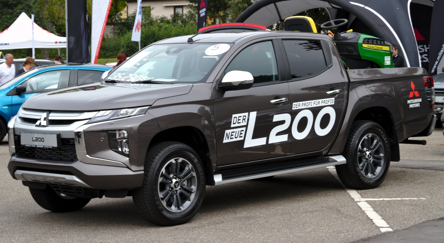 Front and side view of a pickup truck with alloy wheels and signature headlights