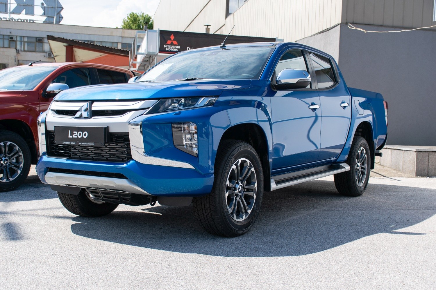 Front and side view of blue double cab pickup with chrome details