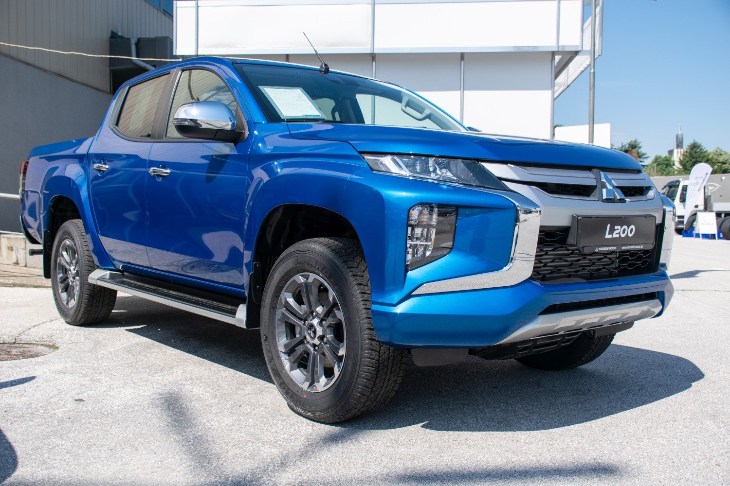 Blue double cab pickup with modern front design and alloy wheels