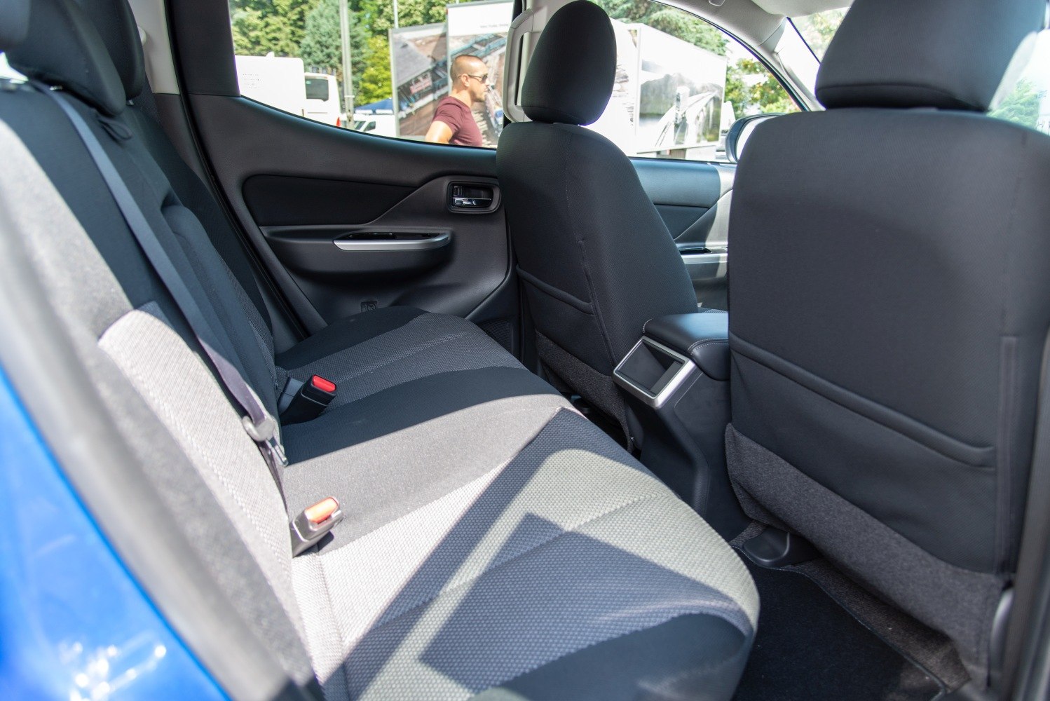 Rear passenger seat interior with fabric upholstery and door panel