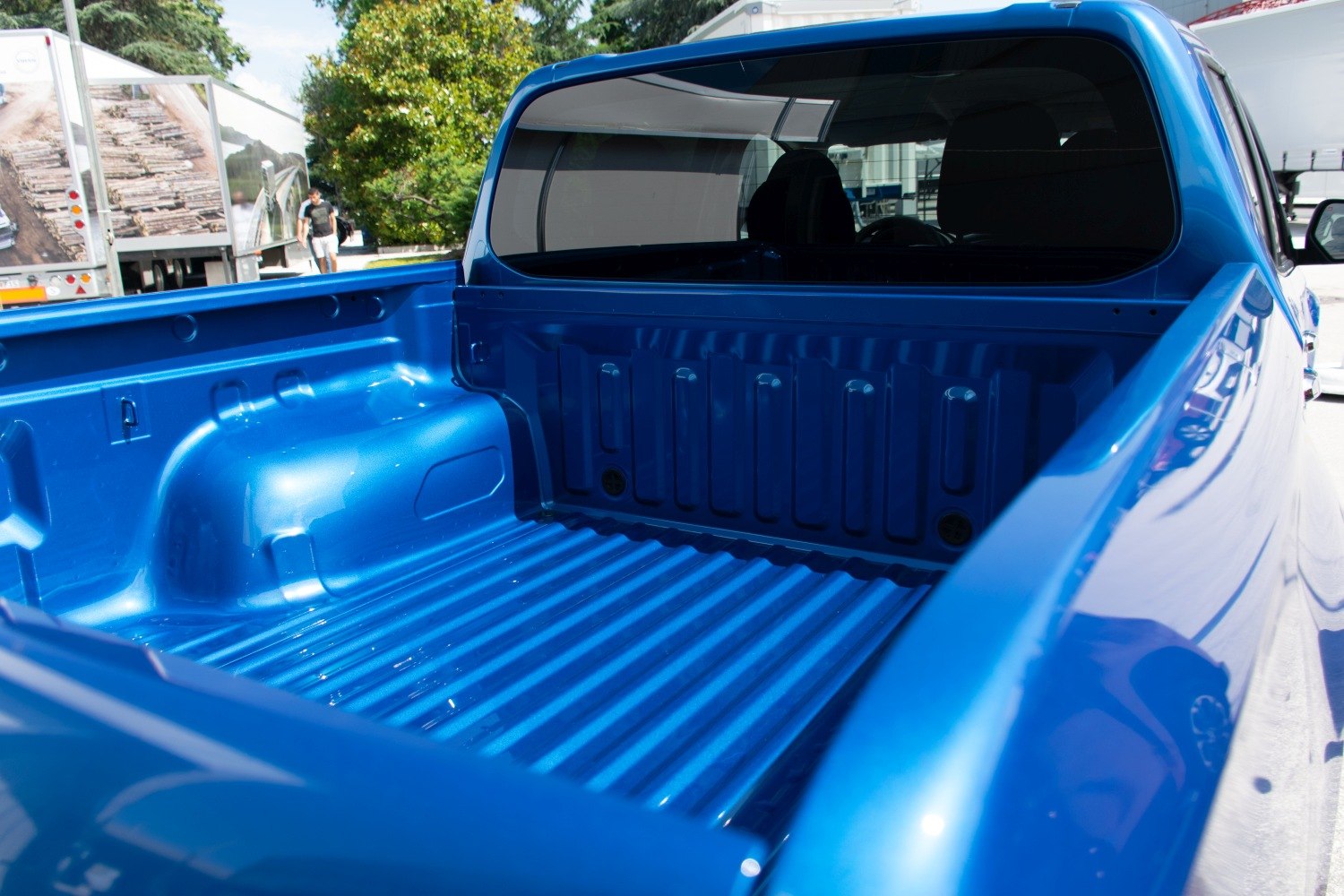 Blue pickup truck bed with spacious cargo area and wheel well arches
