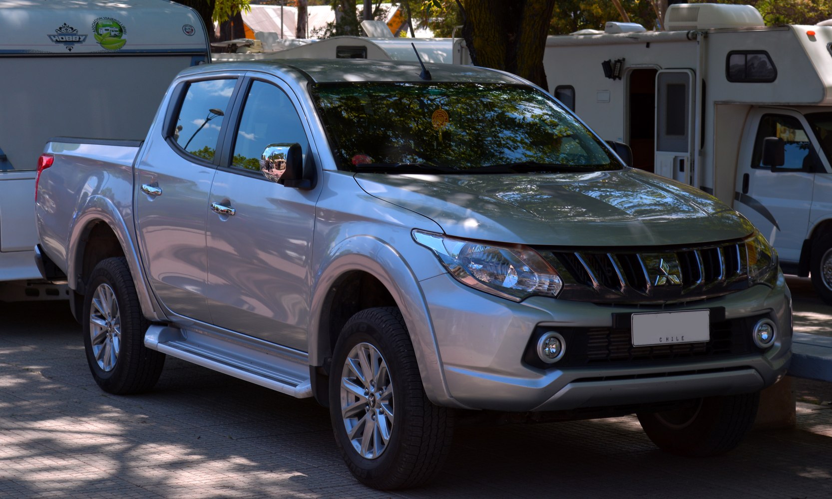 Front side view of a silver double cab pickup with alloy wheels