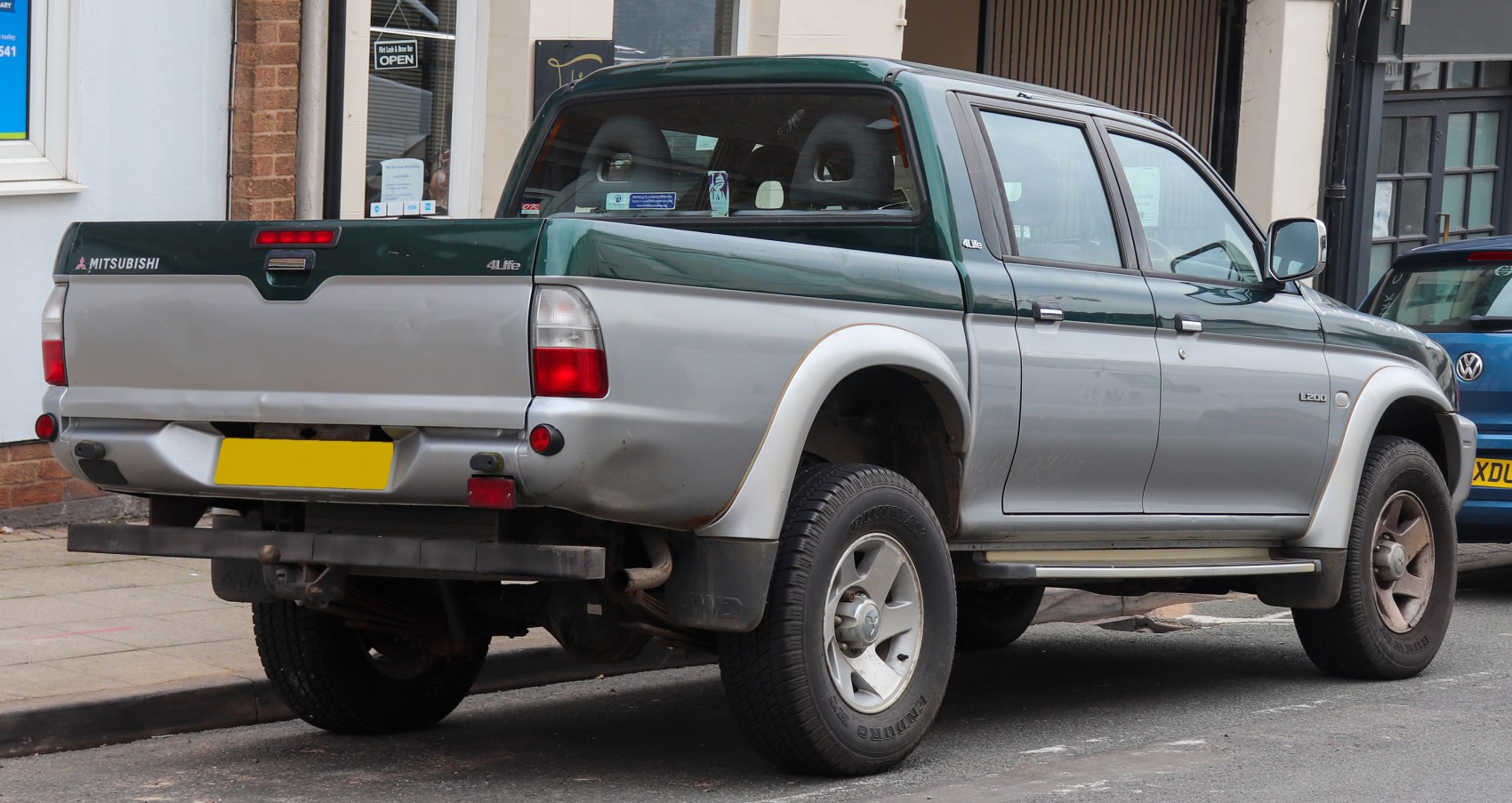 Rear view of double cab pickup with dual-color paint and tailgate