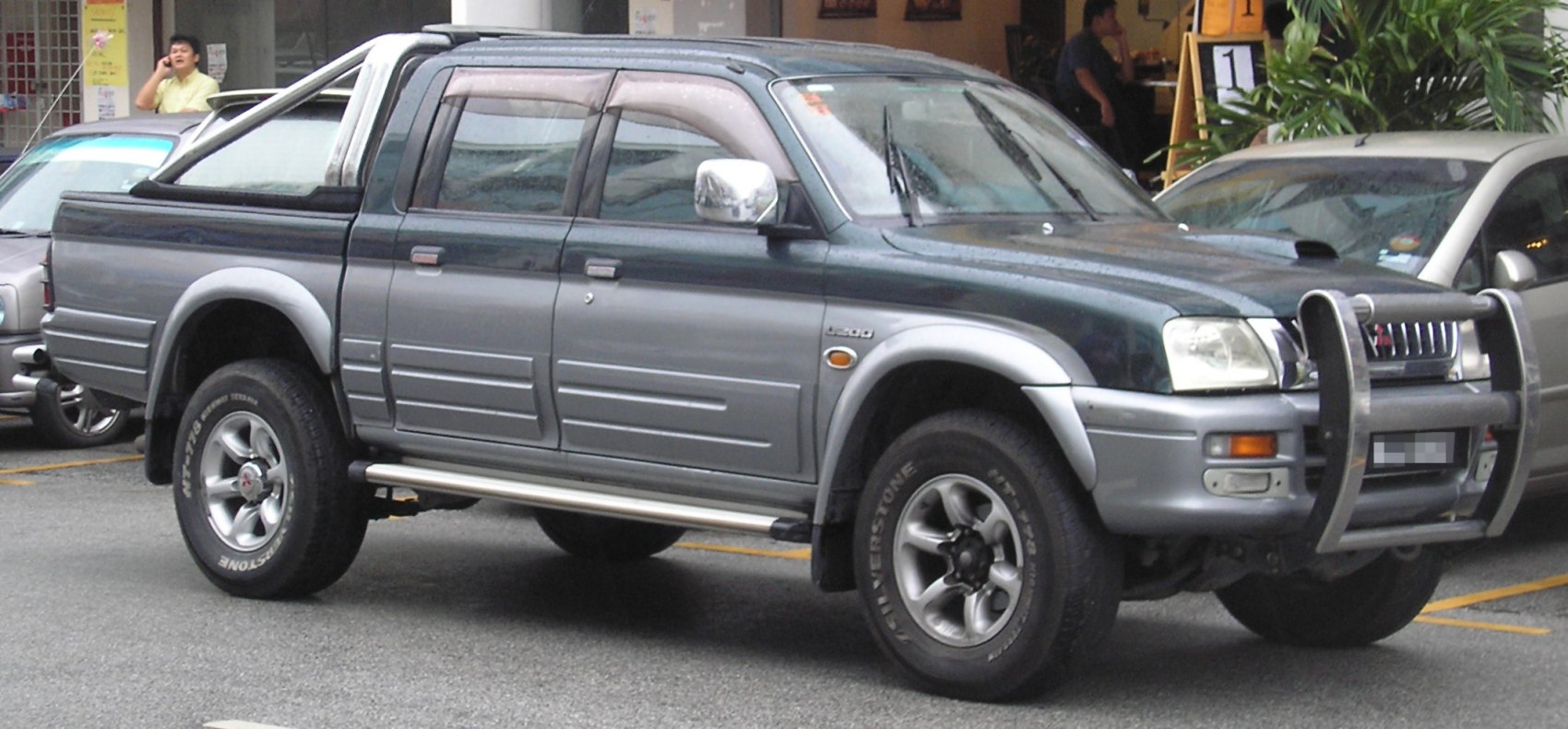 Double cab pickup with bull bar, side steps, and off-road tires