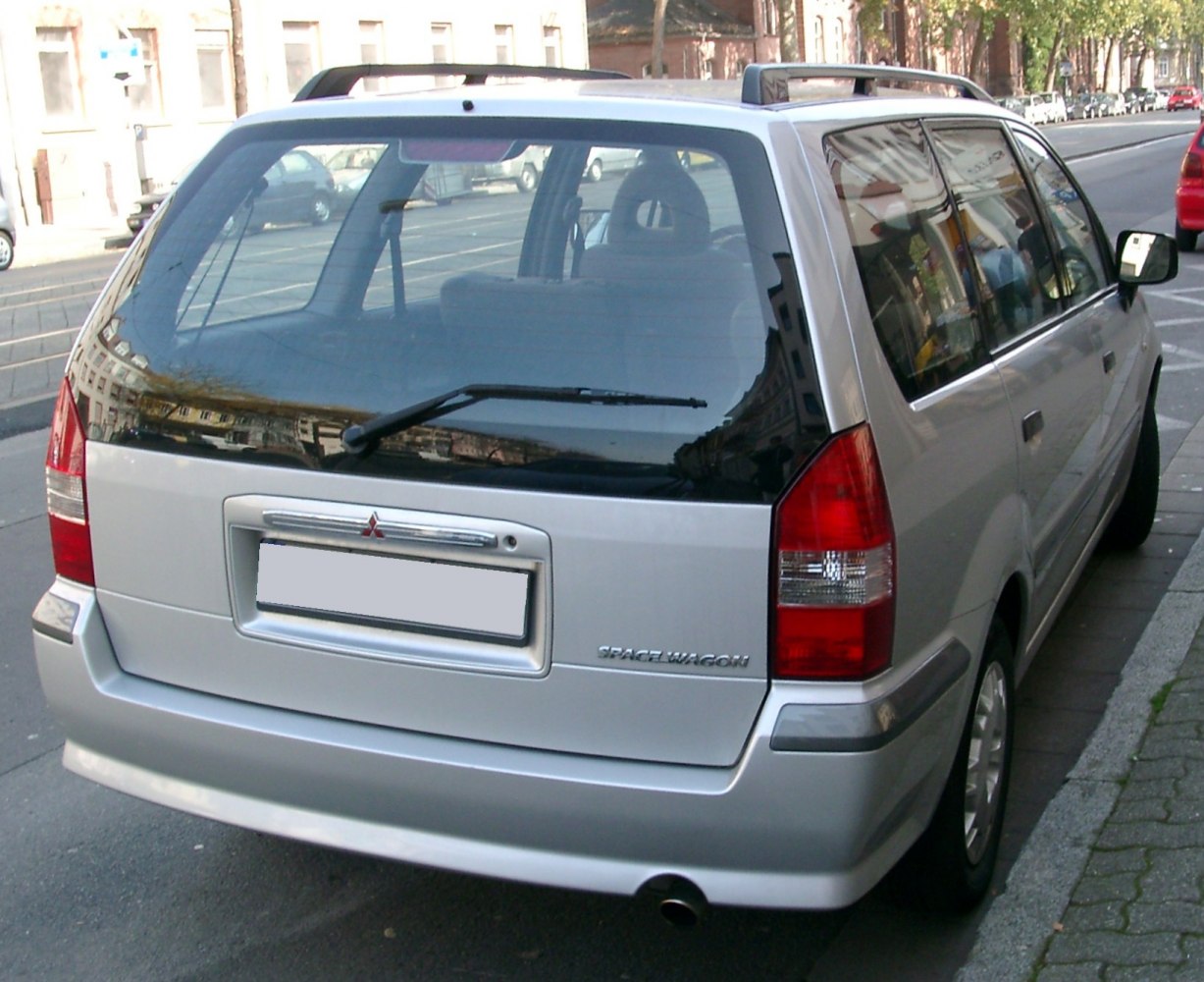 Rear view of a silver spacious wagon with tall taillights and rear wiper