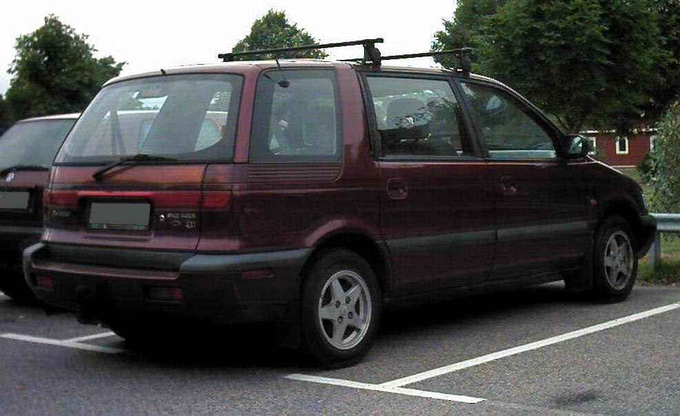 Rear and side profile of a compact minivan with roof rack and alloy wheels