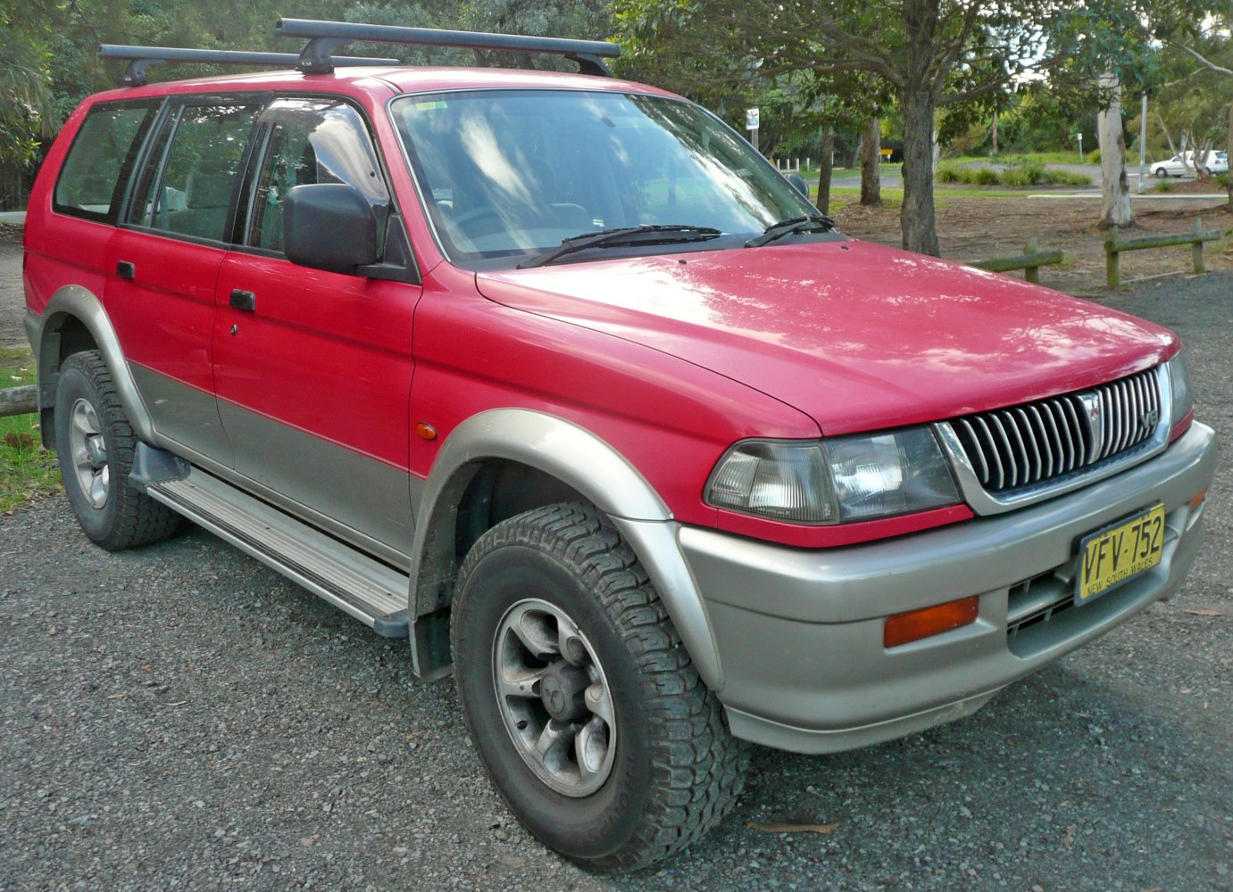 SUV front-side with roof rack and rugged all-terrain tires