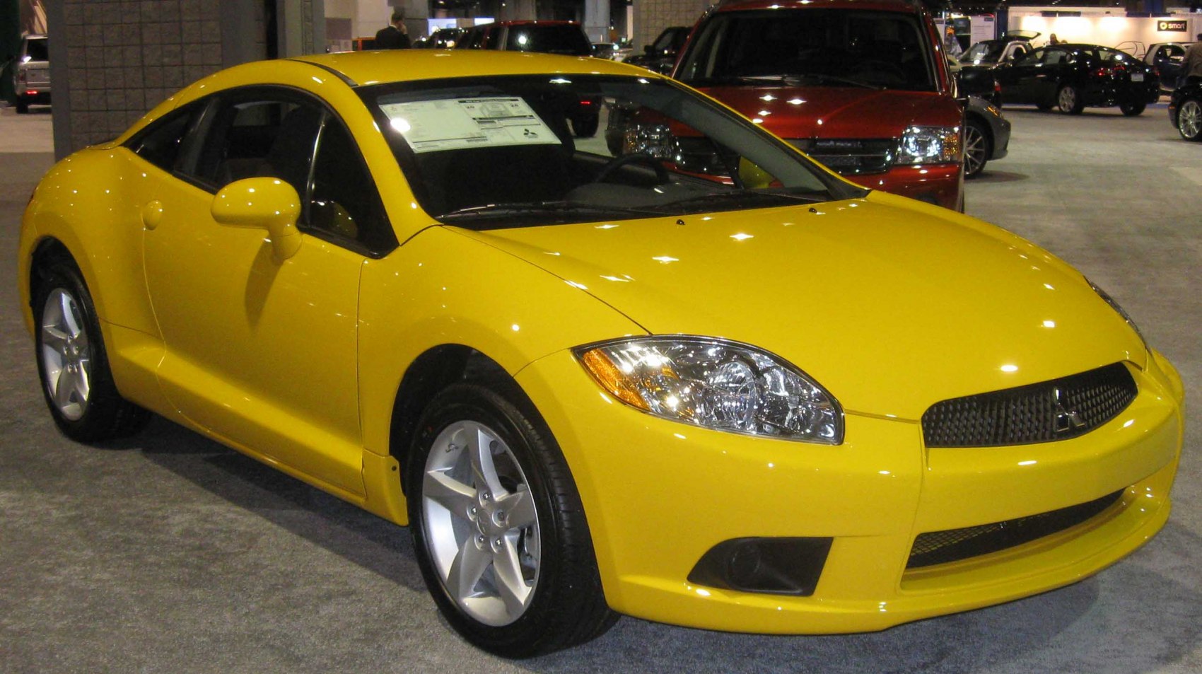 Bright yellow sports coupe with aerodynamic body and alloy wheels