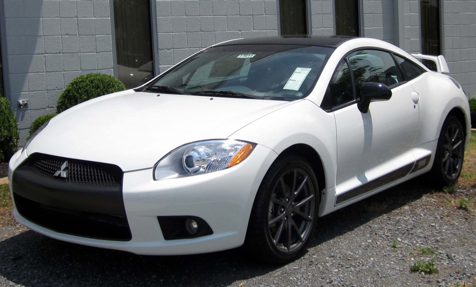 Sporty white coupe with black roof and rear spoiler
