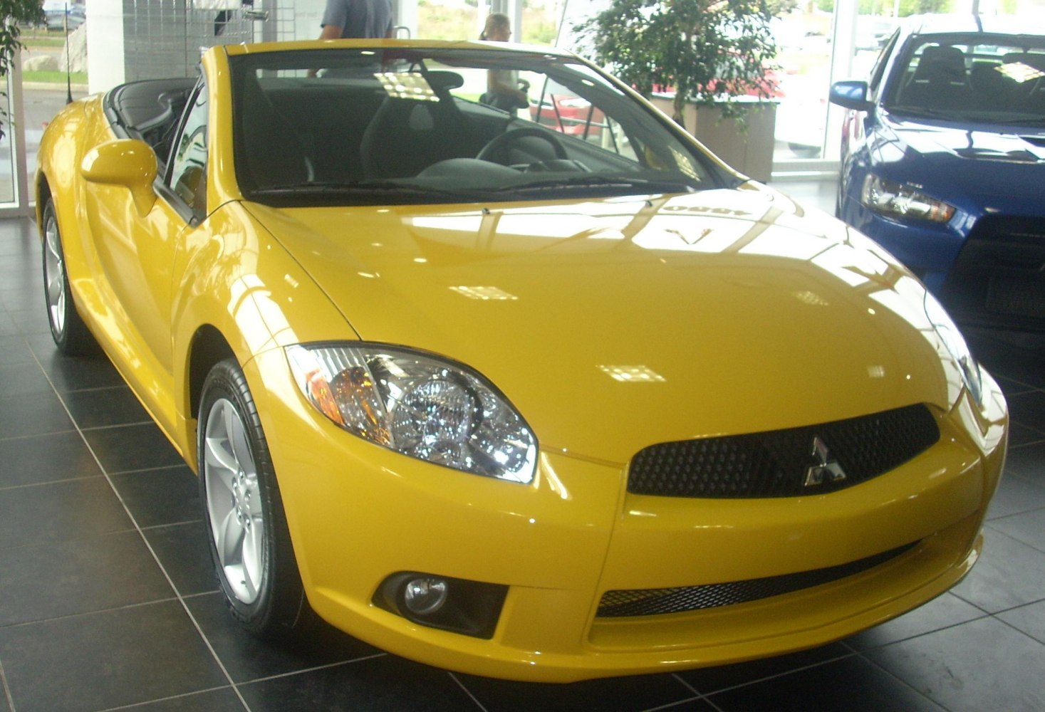 Yellow convertible front view with sporty headlights and grille
