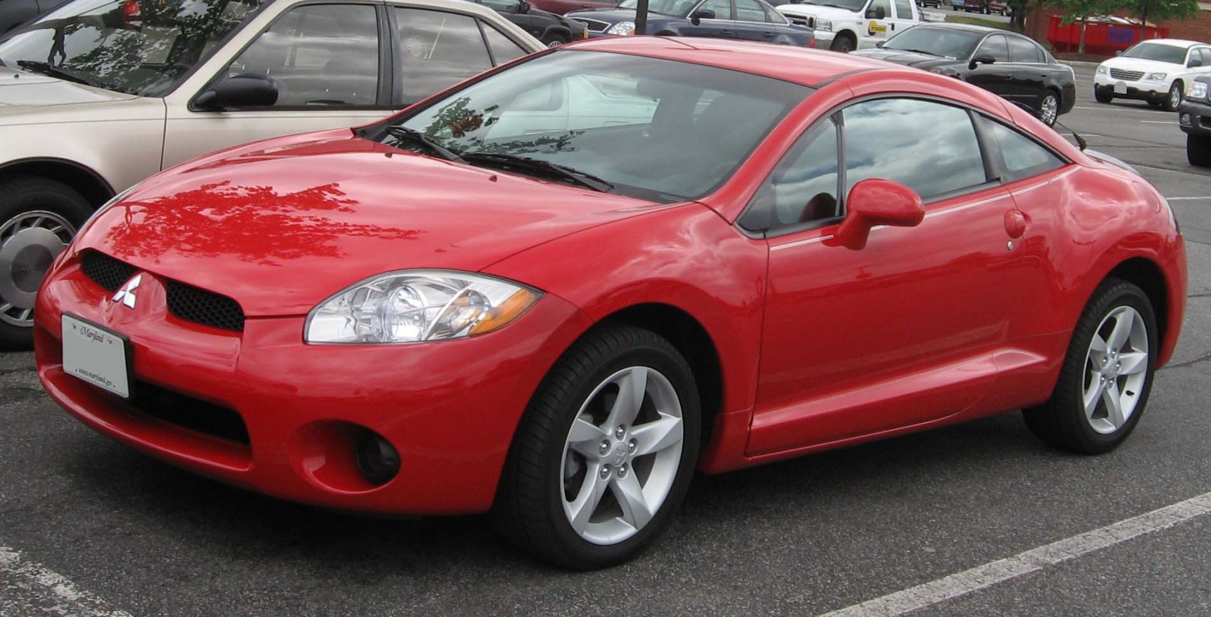 Red sport coupe with smooth curves and alloy wheels.