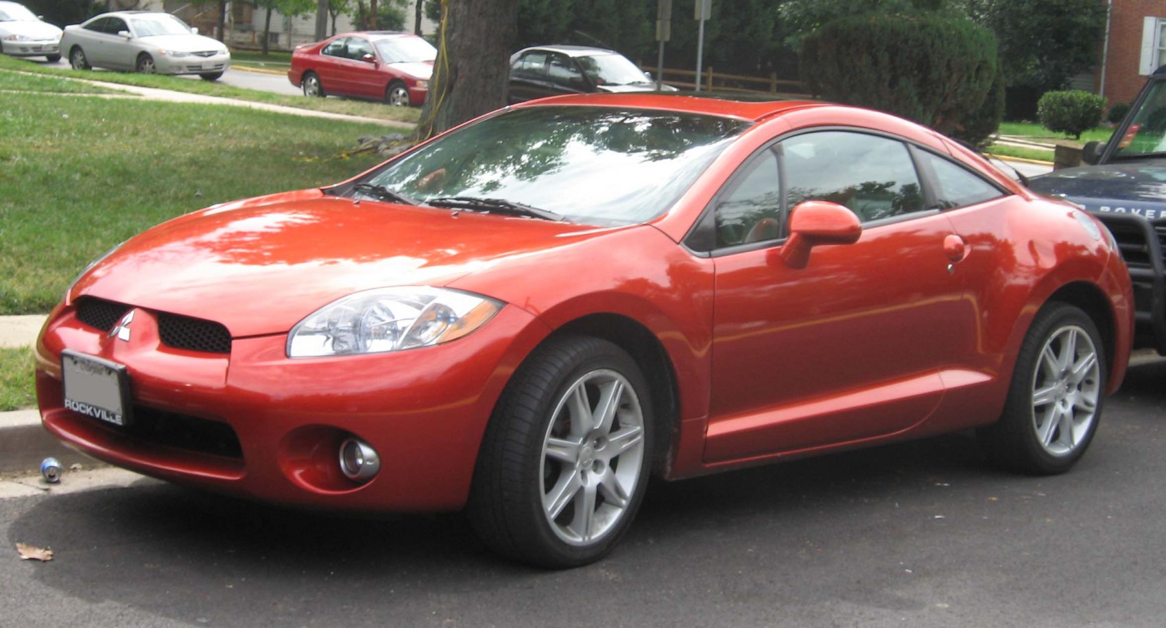 Sporty red coupe front side with alloy wheels