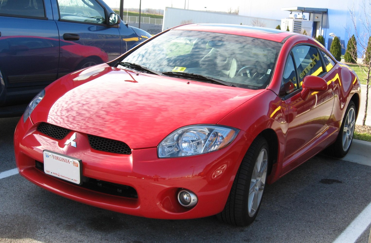 Sporty red coupe front view with clear headlights and grille